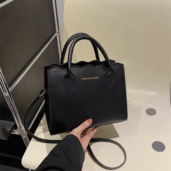 Bolso negro con llavero de cereza